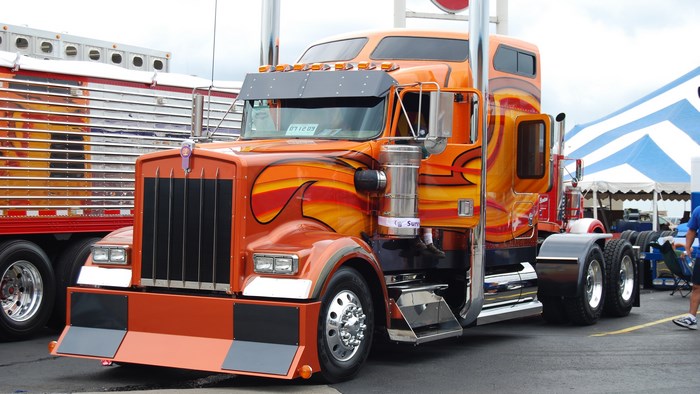 Bright Orange Kenworth Semi Truck with Flames