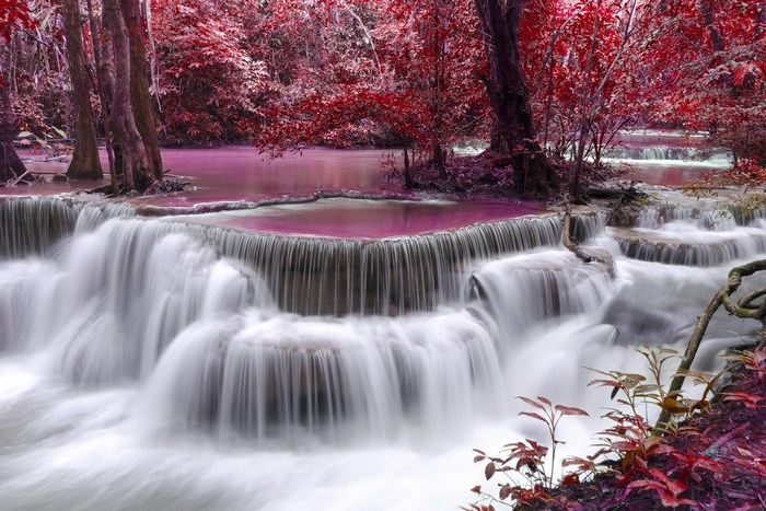 Waterfall with red trees and pink water