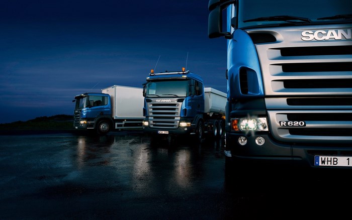 Scania R 620 trucks on wet road at night