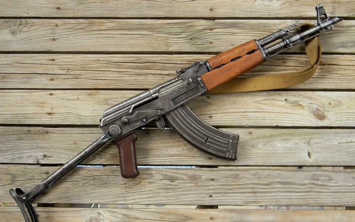 AK-47 assault rifle on wooden planks