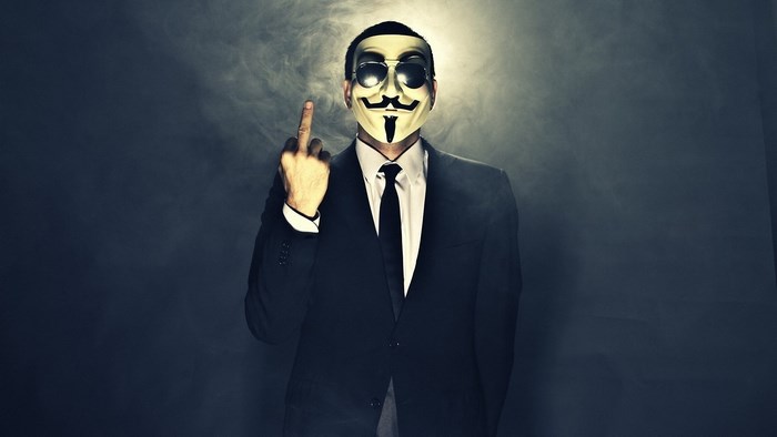 Mysterious Man Wearing Anonymous Mask in Suit