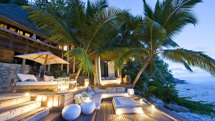 Luxury resort deck with palm trees and ocean view