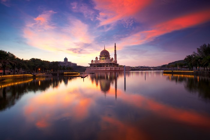 Putra Mosque reflected in water at sunset