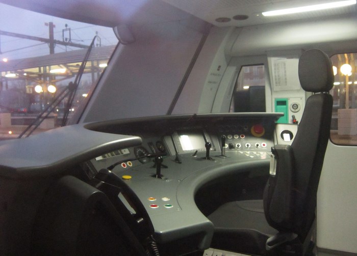 Train driver's cabin with control panel and seat