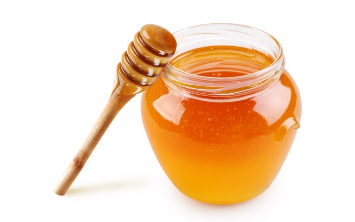 Jar of Golden Honey with Wooden Honey Dipper