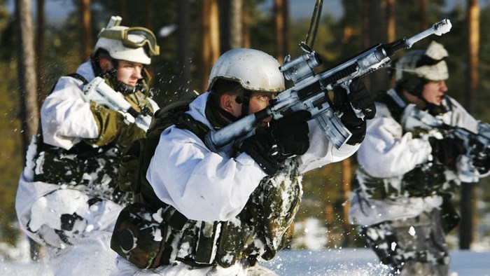 Soldiers in winter camouflage with rifles