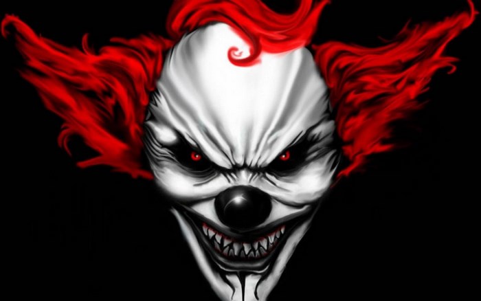Scary clown with red hair and red eyes