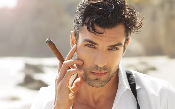 Man with cigar on beach
