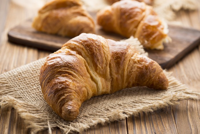 Golden croissants on a wooden table