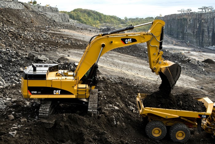 Caterpillar 374D L Excavator Loading Dirt into Truck