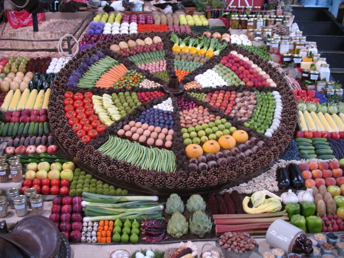 A large circular display of fresh fruits and vegetables