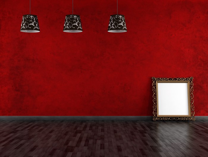 Empty room with red wall and ornate frame