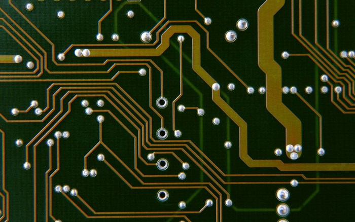 Close-up of a green circuit board with copper traces