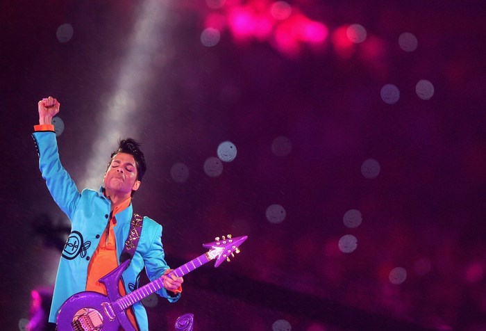 Prince performing on stage with guitar