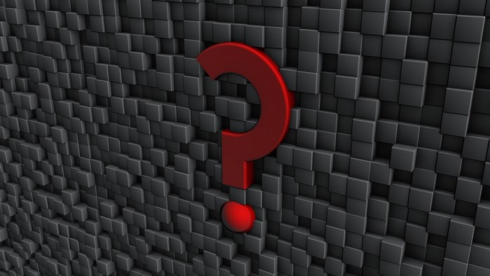 Red question mark on a dark cube background