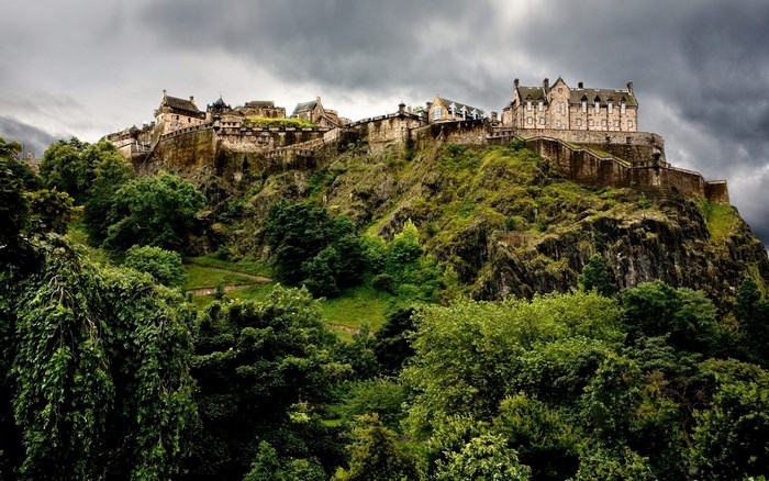Edinburgh Castle on a rocky hill under a cloudy sky