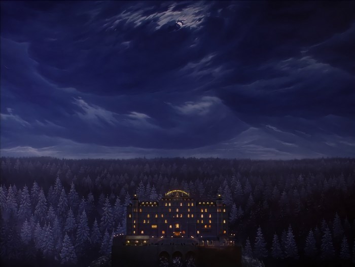 The Grand Budapest Hotel in a snowy forest at night