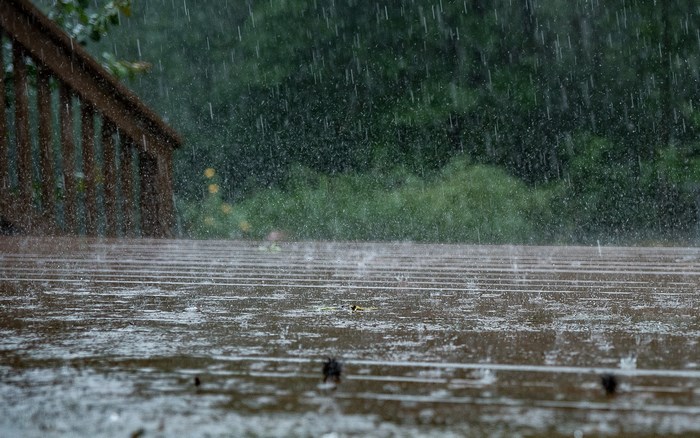 Rain falling on a wooden deck and railing