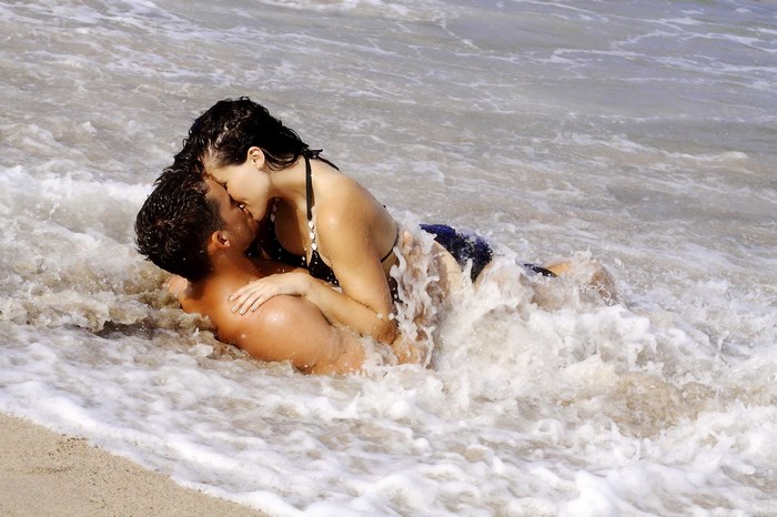 Couple kissing in the ocean waves
