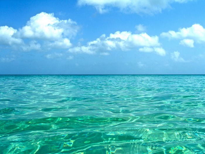 Clear Ocean with Blue Sky and White Clouds