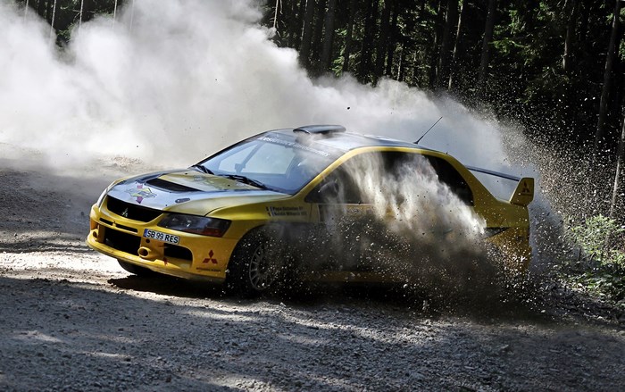 Yellow Mitsubishi Evo Rally Car Drifting on Dirt Road