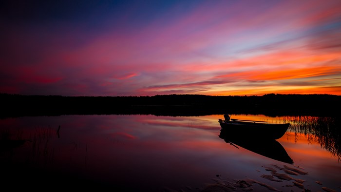Boat on lake at sunset 4K