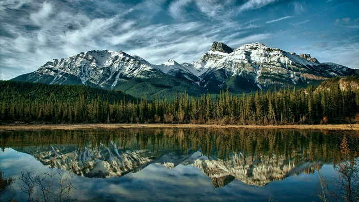 Snow-capped mountains reflected in a calm lake