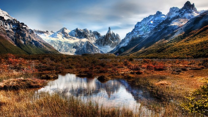 Mountain range with glacier and autumn foliage