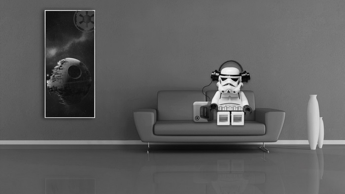 Stormtrooper from Star Wars listening to music on a couch