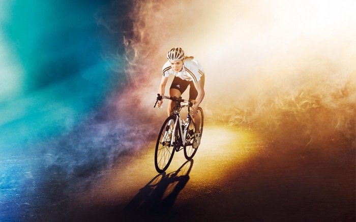 Cyclist in colorful smoke