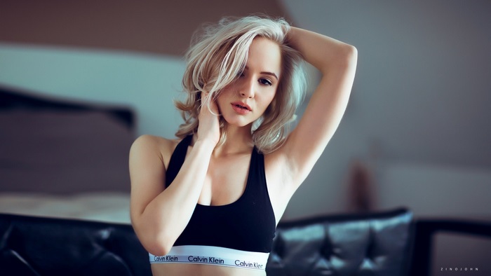 Blonde Woman in Casual Sportswear Relaxing Indoors