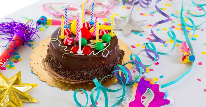 Birthday cake with candles and party decorations