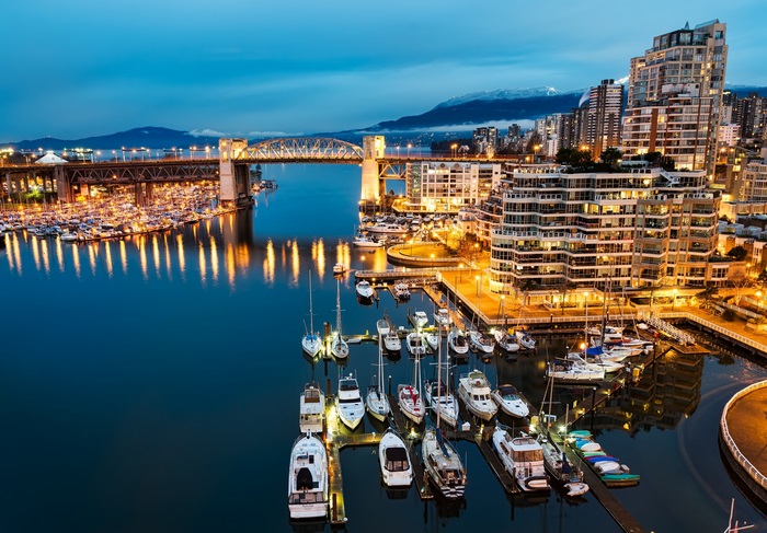 Vancouver cityscape with bridge and marina at dusk