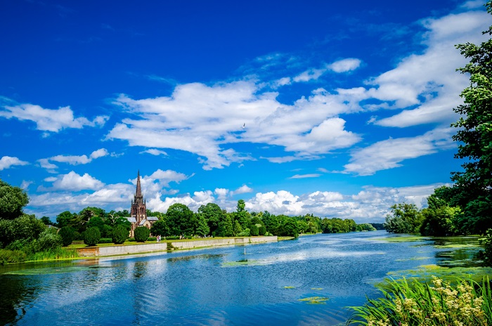 Catholic Church by River Under Blue Sky