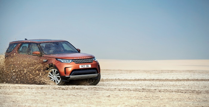 Land Rover Discovery driving through mud
