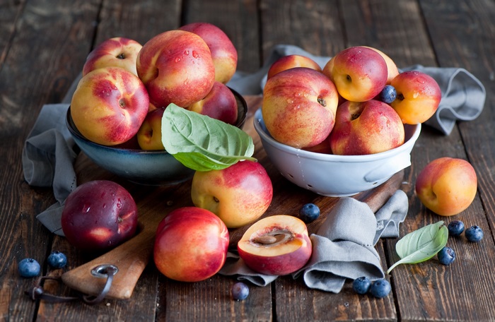 Nectarines and blueberries on wooden table