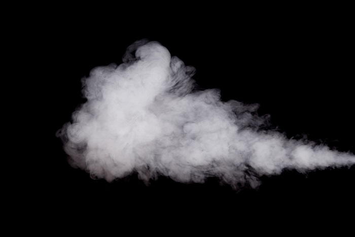 White smoke billowing against a black background
