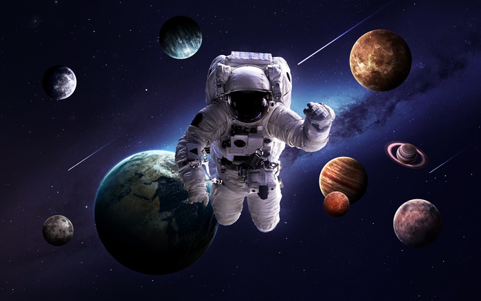 Astronaut floating in space with planets