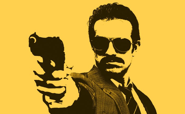 Man in suit holding a gun