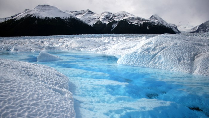 Glacier lake with icebergs and snow-capped mountains