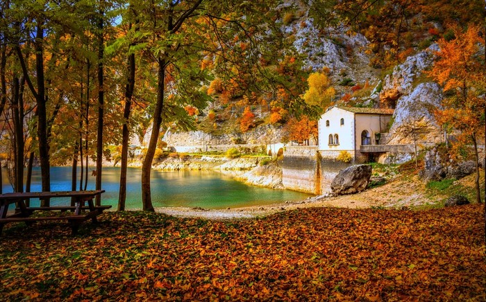 Autumn landscape with a lake and a building in Italy