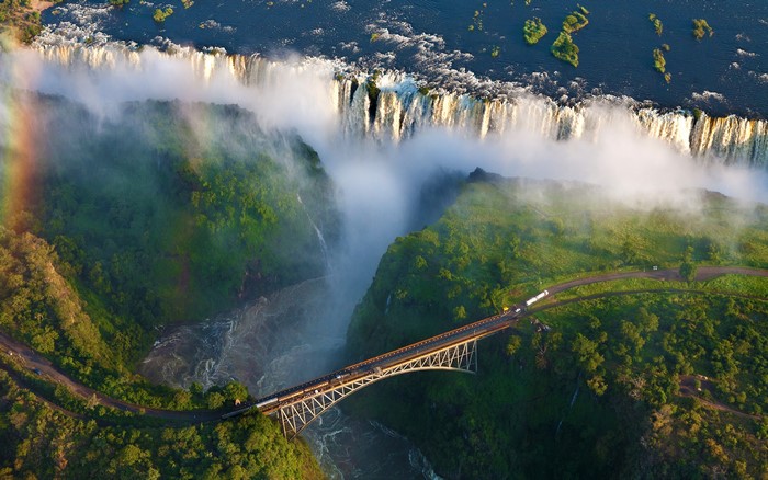 Aerial View of Victoria Falls with Bridge and Rainbow