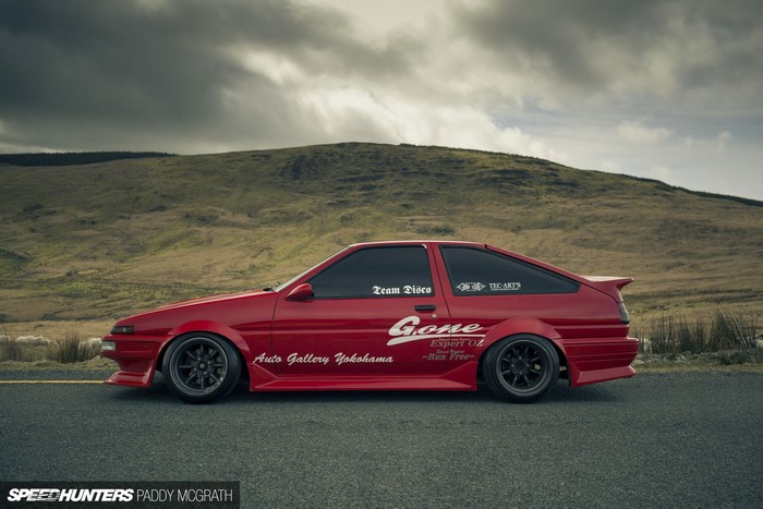 Red Toyota AE86 with 'Gone' livery parked on a road