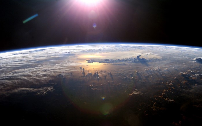 Earth from space with sun and clouds