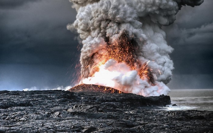Volcano erupting with lava and smoke