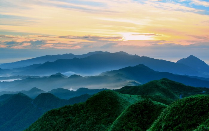 Mountain range with mist at sunset