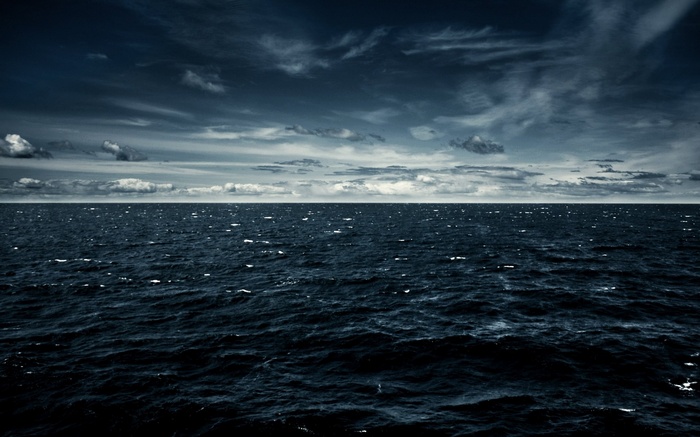 Dark ocean under a cloudy sky