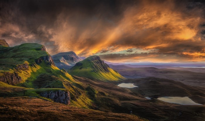 Mountain landscape in Scotland at sunrise with dramatic clouds