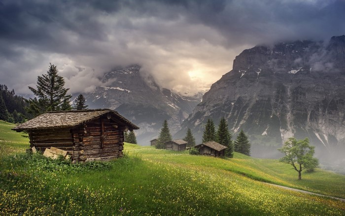 Misty Sunrise Over Mountain Hut in Switzerland