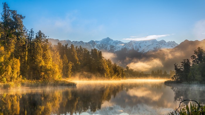 Lake with Misty Mountains and Forest in New Zealand